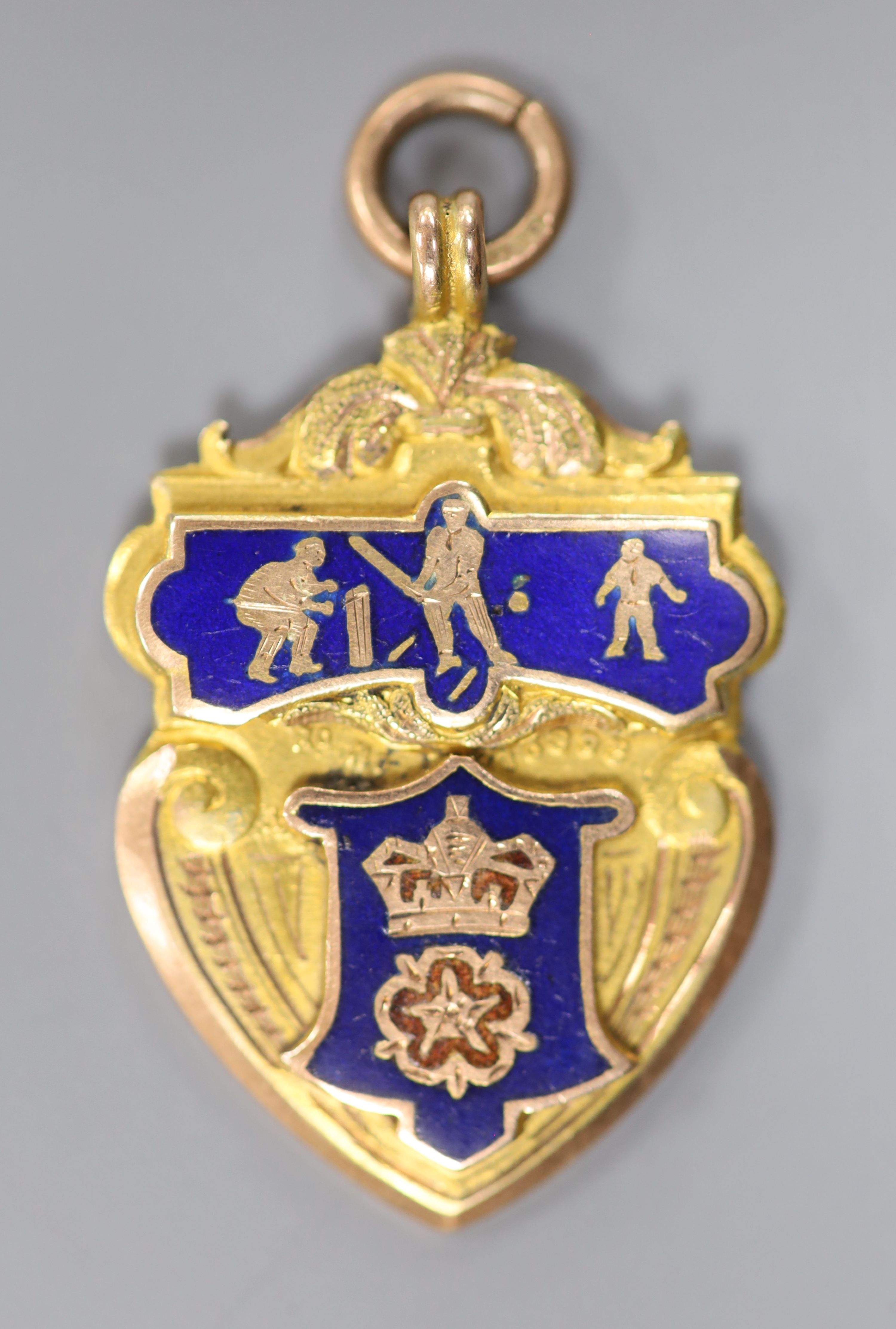 An Edwardian Derbyshire League 9ct gold and enamel cricket medal, Vaughton & Sons, Birmingham, 1909,